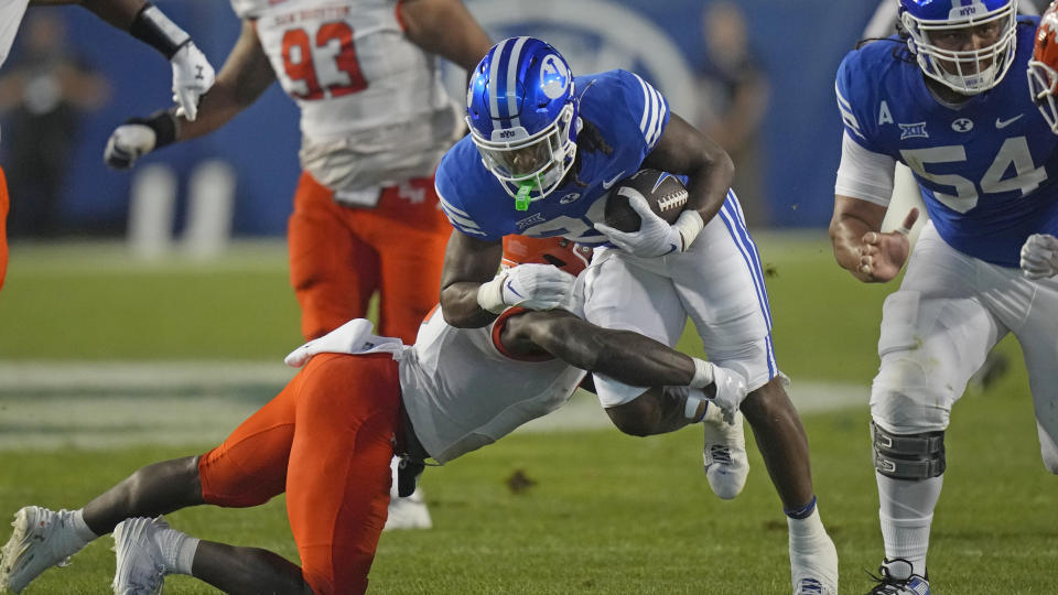 BYU running back Deion Smith (20) carries the ball against Sam Houston State during the first half of an NCAA college football game Saturday, Sept. 2, 2023, in Provo, Utah. (AP Photo/Rick Bowmer)