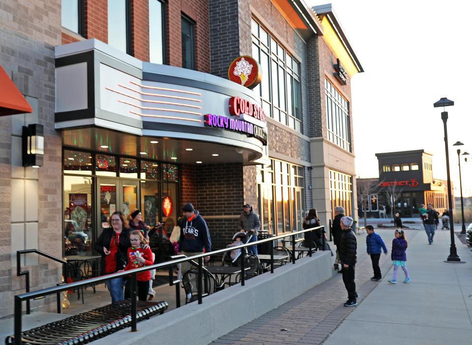 Customers come and go at Cold Stone Creamery during the third annual Dazzling in The District 2019 Holiday Stroll at Prairie Trail in Ankeny.