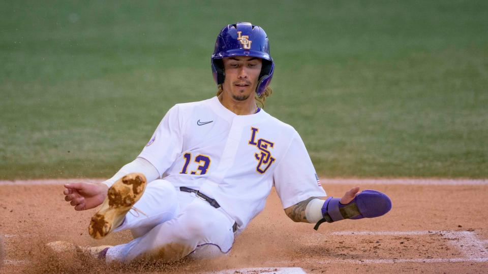 LSU infielder Jordan Thompson (13) slides during an NCAA baseball game against Louisiana-Monroe on Tuesday, March 29, 2022, in Baton Rouge, La. (AP Photo/Matthew Hinton)