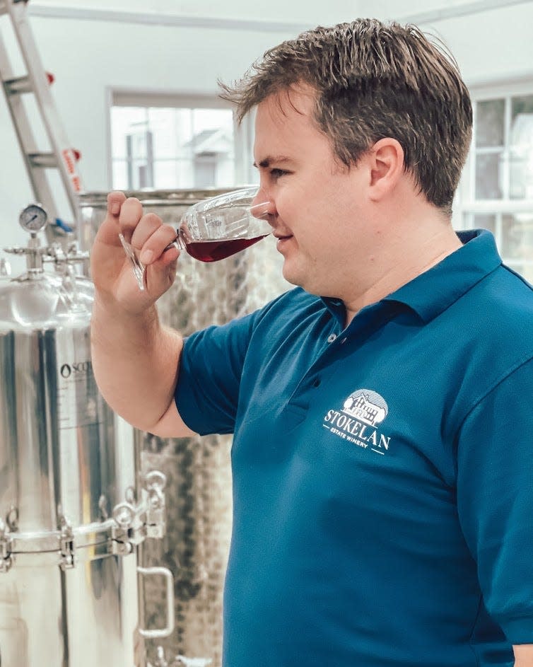 Winemaker Andrew Dick samples red wine by first sniffing and then tasting it at Stokelan Estates Winery among the wine vats in its production room in Medford, Burlington County. The winery is preparing for its anticipated opening July 16, 2022.