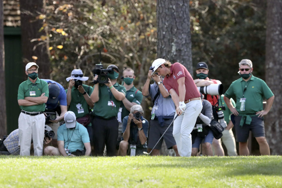 Cameron Smith hits to the 15th hole as course workers and members of the media look on during the final round of the Masters golf tournament Sunday, Nov. 15, 2020, in Augusta, Ga. (Curtis Compton/Atlanta Journal-Constitution via AP)