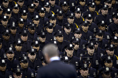 New York Mayor Bill de Blasio speaks from the podium to the New York City Police Academy Graduating class in New York December 29, 2014. REUTERS/Carlo Allegri