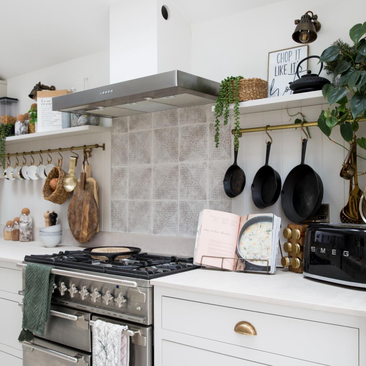  Gas stove in white themed kitchen 