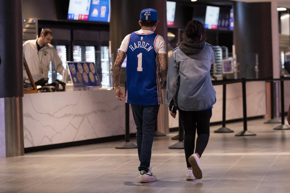 A Philadelphia 76ers fan wears a James Harden jersey prior to a preseason NBA basketball game against the Atlanta Hawks, Friday, Oct. 20, 2023, in Philadelphia. (AP Photo/Chris Szagola)