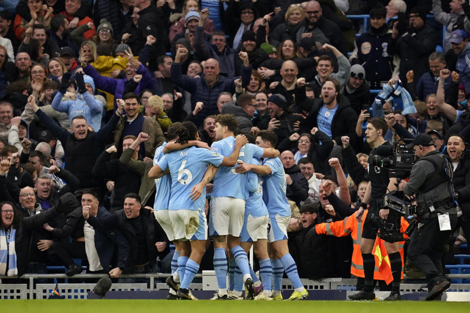 Manchester City players and supporters celebrate after Manchester City's Phil Foden scores his side's second goal during an English Premier League soccer match between Manchester City and Manchester United at the Etihad Stadium in Manchester, England, Sunday, March 3, 2024. (AP Photo/Dave Thompson)