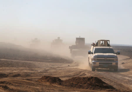 Members of the Iraqi security forces ride a military vehicle during clashes with Islamic State militants at the south of Mosul, Iraq December 12, 2016. REUTERS/Ammar Awad