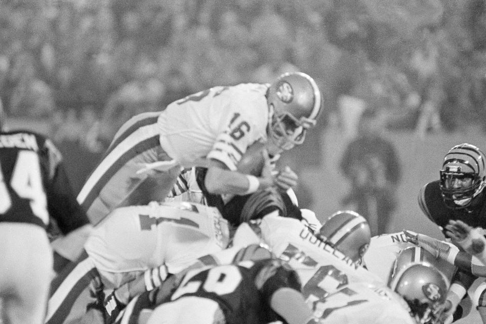 FILE - In this Jan. 24, 1982, file photo, San Francisco 49ers quarterback Joe Montana (16) sneaks across the goal line for the 49ers first score in the first quarter of Super Bowl XVI at the Pontiac Silverdome in Pontiac, Mich. What doach Kyle Shanahan, quarterback Jimmy Garoppolo, defensive end Nick Bosa and the rest of the San Francisco 49ers are doing this year harkens back to 1981 when Bill Walsh, Joe Montana and Ronnie Lott led the franchise to its first Super Bowl title. (AP Photo/Ray Stubblebine, File)