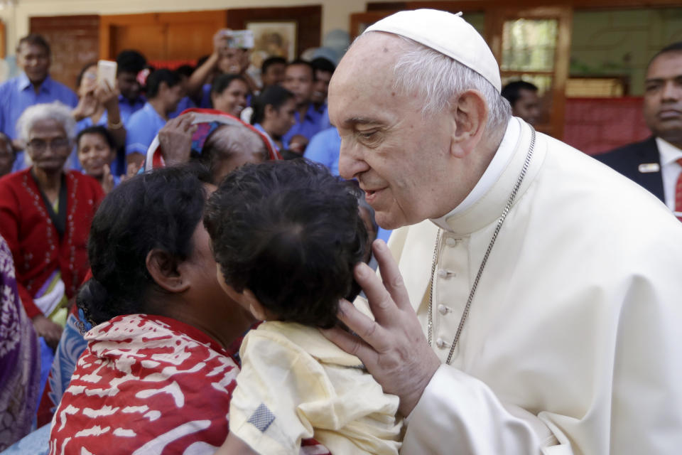 Pope Francis kisses a child as he meets with sick people and staff of the Mother Teresa House in Dhaka’s Tejgaon neighborhood, Bangladesh, Saturday, Dec. 2, 2017. (AP Photo/Andrew Medichini, Pool)