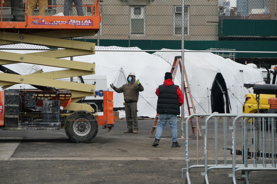 Workers construct what is believed to be a makeshift morgue behind a hospital during the outbreak of coronavirus disease (COVID-19), in the Manhattan borough of New York City