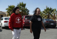 Ron Jeremy, right, and Heidi Fleiss walk out of the Love Ranch brothel, Tuesday, Oct. 16, 2018, in Pahrump, Nev. Dennis Hof, a legal pimp and Republican candidate has died at the brothel according to Nevada authorities. (AP Photo/John Locher)