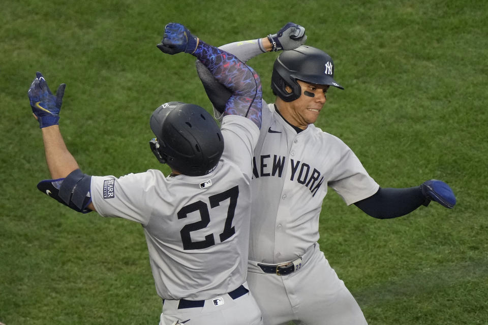 New York Yankees' Giancarlo Stanton (27) celebrates with Juan Soto after hitting a two-run home run during the fifth inning of a baseball game against the Kansas City Royals Wednesday, June 12, 2024, in Kansas City, Mo. (AP Photo/Charlie Riedel)