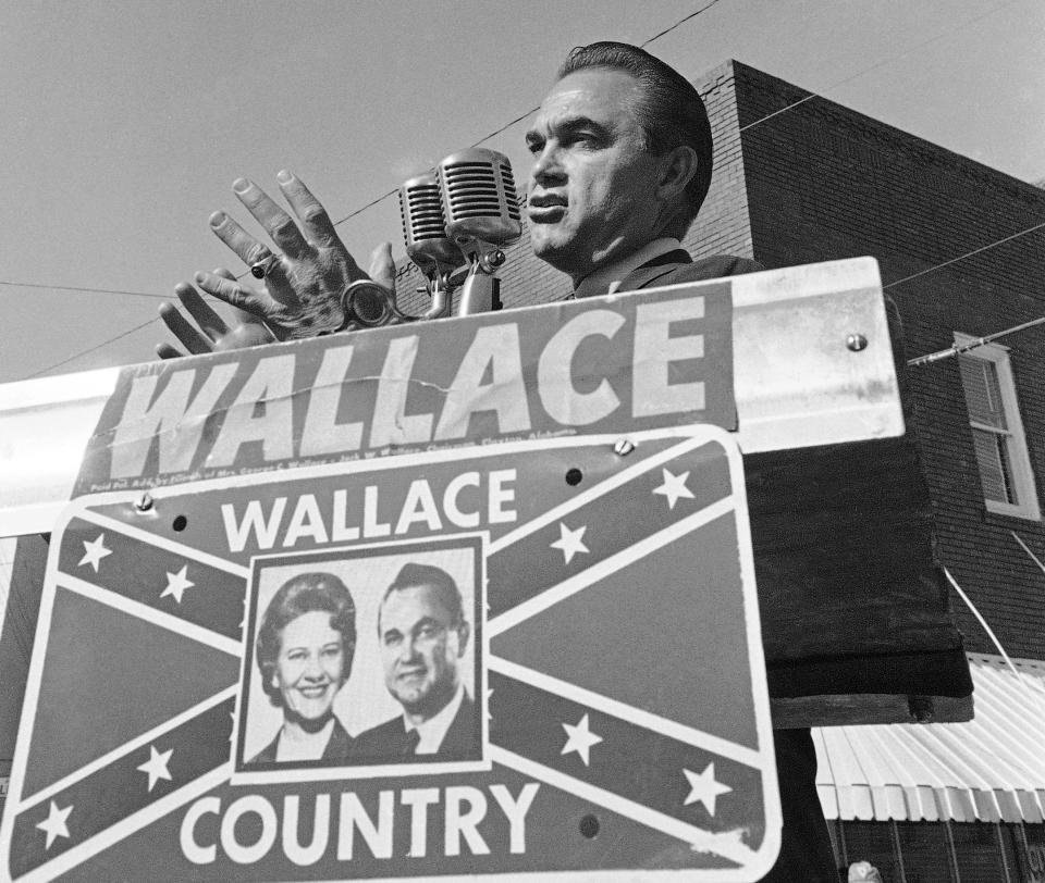 FILE - Alabama Gov. George C. Wallace gestures as he makes an election campaign speech for his wife, Lurleen, Nov. 8, 1966, in Wetumpka, Ala. Republican presidential candidates will debate Wednesday, Dec. 6, 2023, within walking distance of where Wallace staged his “stand in the schoolhouse door” to oppose the enrollment of Black students at the University of Alabama during the Civil Rights Movement. (AP Photo/LG, File)