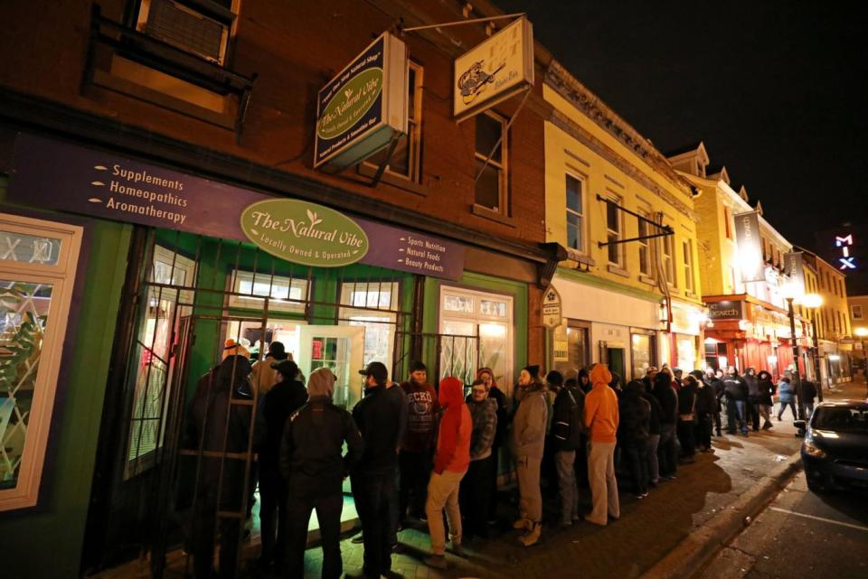 Customers line up outside the Natural Vibe store after legal recreational marijuana went on sale in St John's, Newfoundland (Chris Wattie/Reuters)