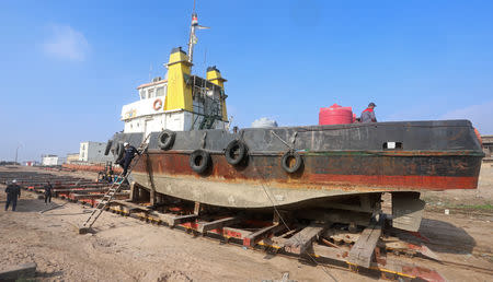 FILE PHOTO: Workers repair an Iraqi ship at a shipyard built by the British Army on Basra's docks in 1918, in Basra, Iraq December 23, 2018. REUTERS/Essam al-Sudani/File Photo