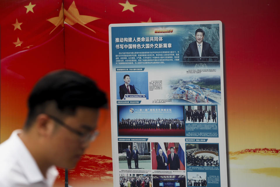 A man walks by a government propaganda billboard promoting Chinese President Xi Jinping's signature "One Belt One Road" outside a subway station in Beijing, Tuesday, Aug. 28, 2018. Chinese officials on Monday defended Beijing's initiative to build a "New Silk Road" of railways and other infrastructure across Asia against complaints it leaves host countries with too much debt after Malaysia canceled two high-profile projects. The officials said President Xi Jinping's signature foreign policy initiative is creating assets that are needed by developing countries but might take time to pay off. (AP Photo/Andy Wong)