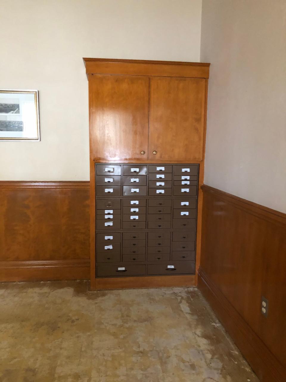 M.F. and Oscar Hawkins built the paneling, stairs, cabinets and inlaid wood floors throughout the house. The cabinet in the Bivins Home still holds old library index cards from the past.