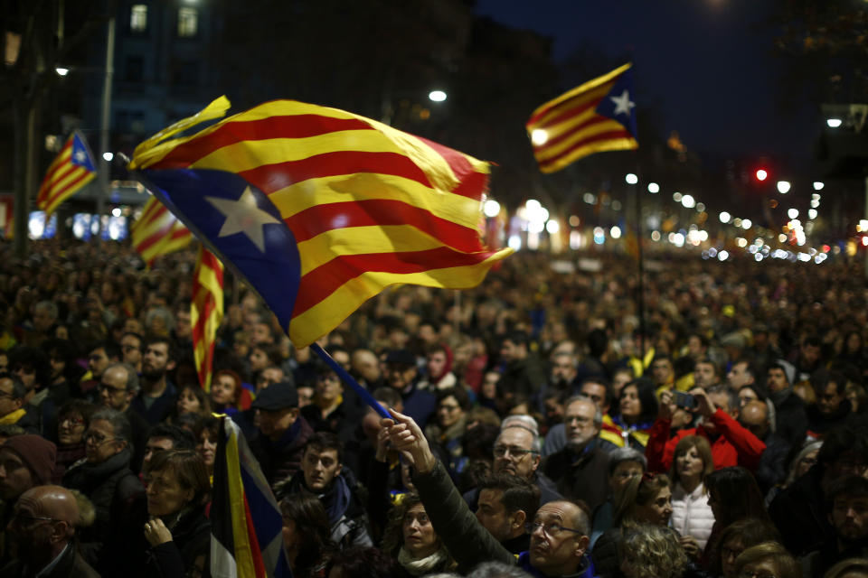 Demonstrators march along the street, during a protest in Barcelona, Spain, Thursday, Feb. 21, 2019. Protesters backing Catalonia's secession from Spain clashed with police and blocked major roads and train tracks across the northeastern region on Thursday during a strike called to protest the trial of a dozen separatist leaders. (AP Photo/Manu Fernandez)