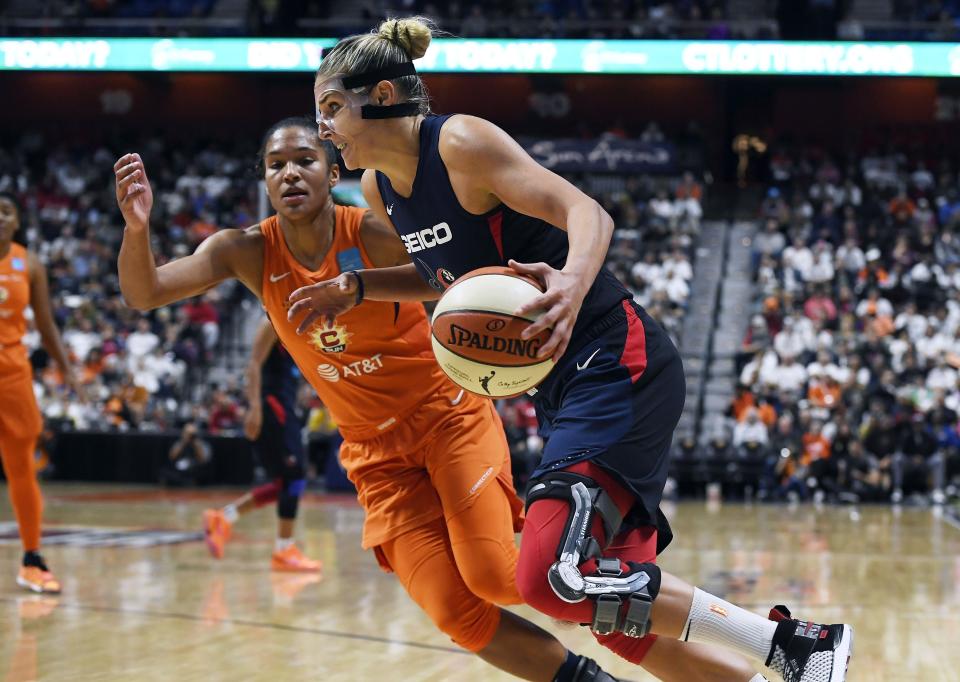 Washington Mystics' Elena Delle Donne, front, drives to the basket against Connecticut Sun's Alyssa Thomas during the second half in Game 3 of basketball's WNBA Finals, Sunday, Oct. 6, 2019, in Uncasville, Conn. (AP Photo/Jessica Hill)
