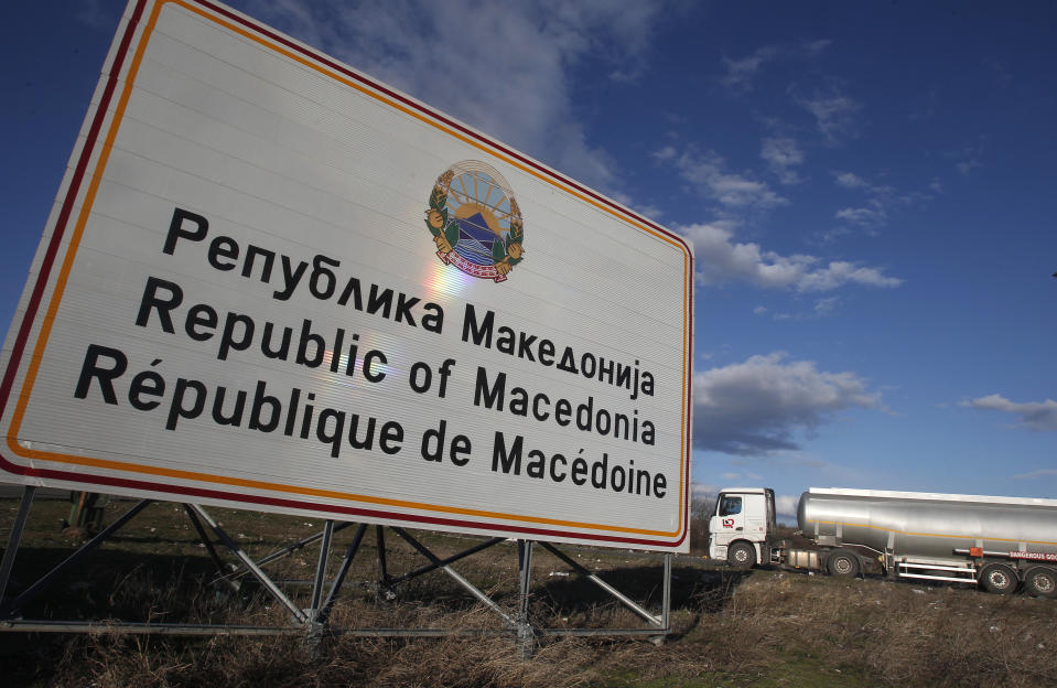 A tank truck drives by a road sign reading "Republic of Macedonia" entering from Greece into Macedonia at Bogorodica border crossing, on Macedonia's southern border with Greece, Tuesday, Feb. 12, 2019. Macedonian authorities began Monday removing official signs from government buildings to prepare for the country's new name: North Macedonia. (AP Photo/Boris Grdanoski)