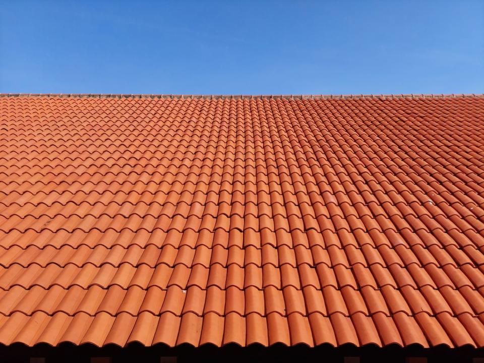 roof of building with clay tiles against clear sky