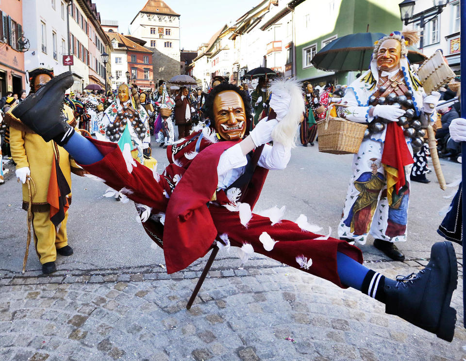 <p>A young Federahannes, a jester figure from Rottweil, participates in the Narrensprung (jester jump) parade in Rottweil, southern Germany, Monday, Feb. 27, 2016. (AP Photo/Michael Probst) </p>