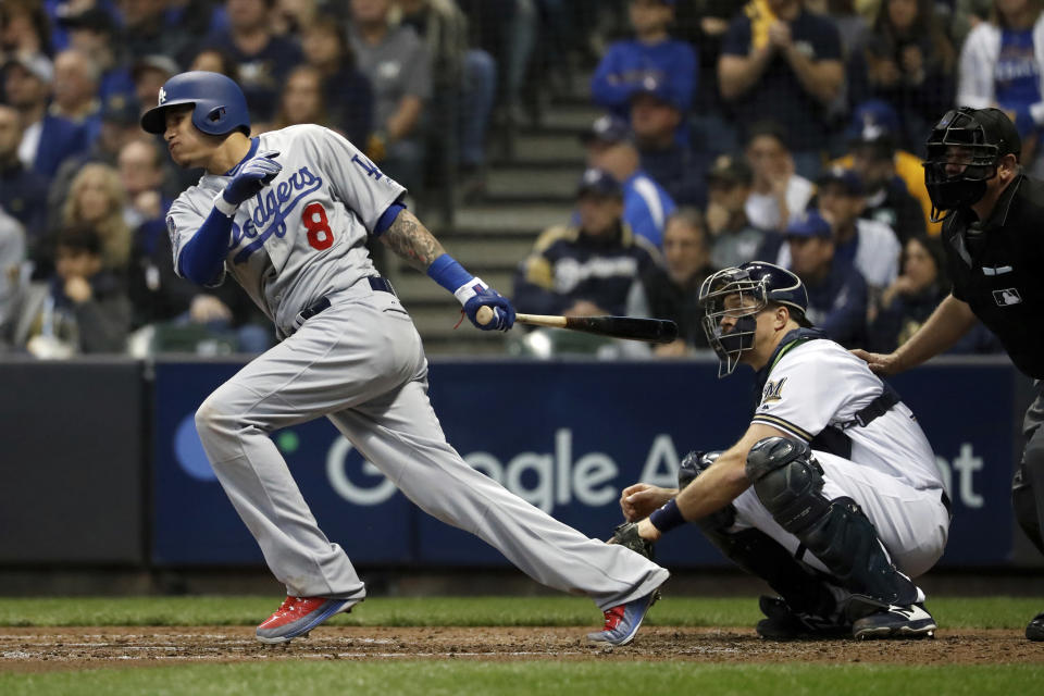 FILE - In this Oct. 20, 2018, file photo, then-Los Angeles Dodgers' Manny Machado (8) hits a single during the fourth inning of Game 7 of the National League Championship Series baseball game against the Milwaukee Brewers, in Milwaukee. A person familiar with the negotiations tells The Associated Press that infielder Manny Machado has agreed to a $300 million, 10-year deal with the rebuilding San Diego Padres, the biggest contract ever for a free agent. The person spoke to the AP on condition of anonymity Tuesday, Feb. 19, 2019, because the agreement was subject to a successful physical and had not been announced.(AP Photo/Jeff Roberson, File)