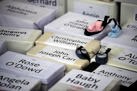 FILE PHOTO: Funeral boxes, each representing a dead child, are placed together at a procession in remembrance of the bodies of infants discovered in a septic tank, in 2014, at the Tuam Mother and Baby Home, in Dublin, Ireland, October 6, 2018. REUTERS/Clodagh Kilcoyne/File Photo