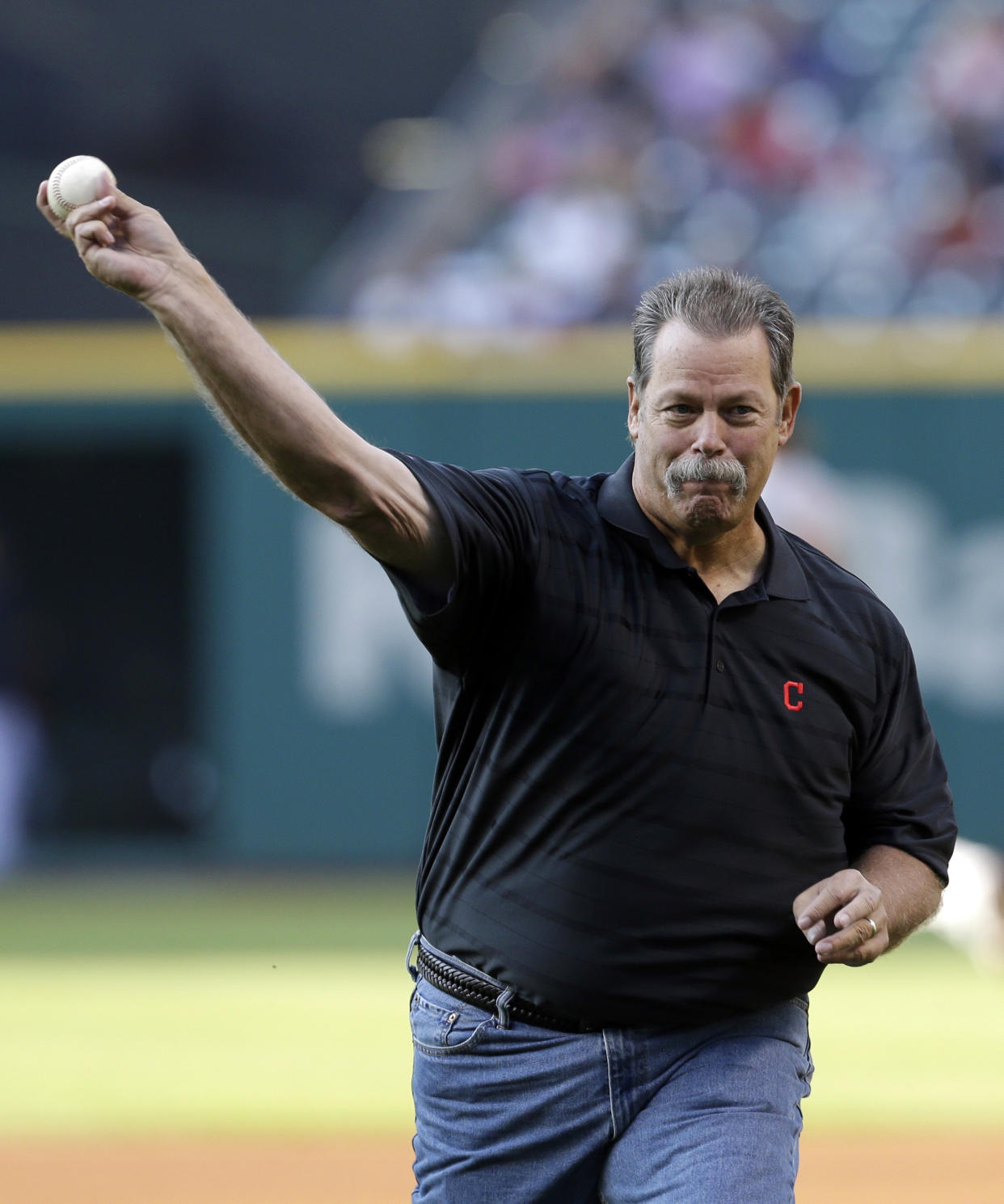 FILE - Former Cleveland Indians relief pitcher Doug Jones throws out the ceremonial first pitch before Cleveland played the Washington Nationals in a baseball game June 14, 2013, in Cleveland. Jones, a five-time All-Star reliever who had his best success closing for the Indians, has died. He was 64. Jones spent seven seasons with the Indians and ranks third on the club's career saves list with 129. (AP Photo/Tony Dejak, File)