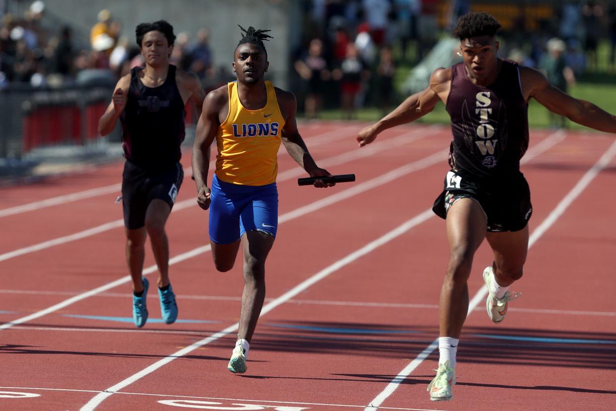 Gahanna Lincoln's Makai Shahid and Stow-Munroe Falls' Xavier Preston cross the finish line in the 800 relay during the Division I state meet June 4 at Ohio State. Stow won in 1:26.1 and the Lions were second in 1:26.5.
