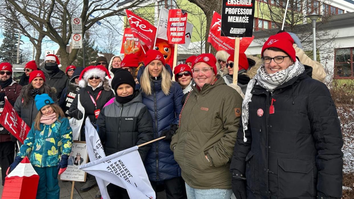 Marion Miller, right, and Rosaline Meunier, second from right, are on the FAE picket line demanding better work conditions for teachers.  (Erika Morris/CBC - image credit)