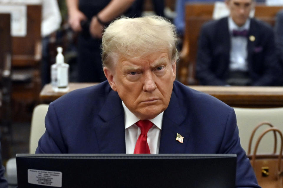 FILE - Former President Donald Trump sits during his civil fraud trial at the State Supreme Court building in New York, Oct. 4, 2023. Trump is set to be questioned under oath as part of lawsuits from two former FBI employees who provoked the former president's outrage after sending each other pejorative text messages about him.(Angela Weiss/Pool via AP)