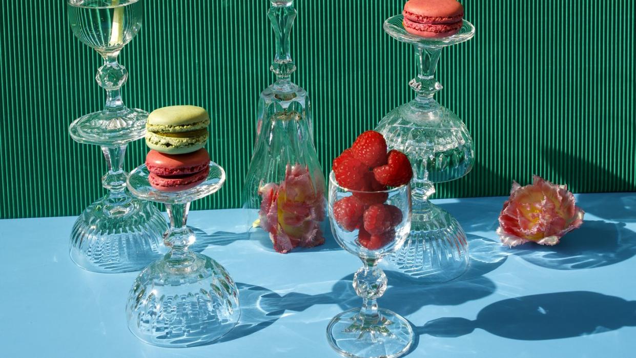 close up of macarons and pink flowers on the green blue background