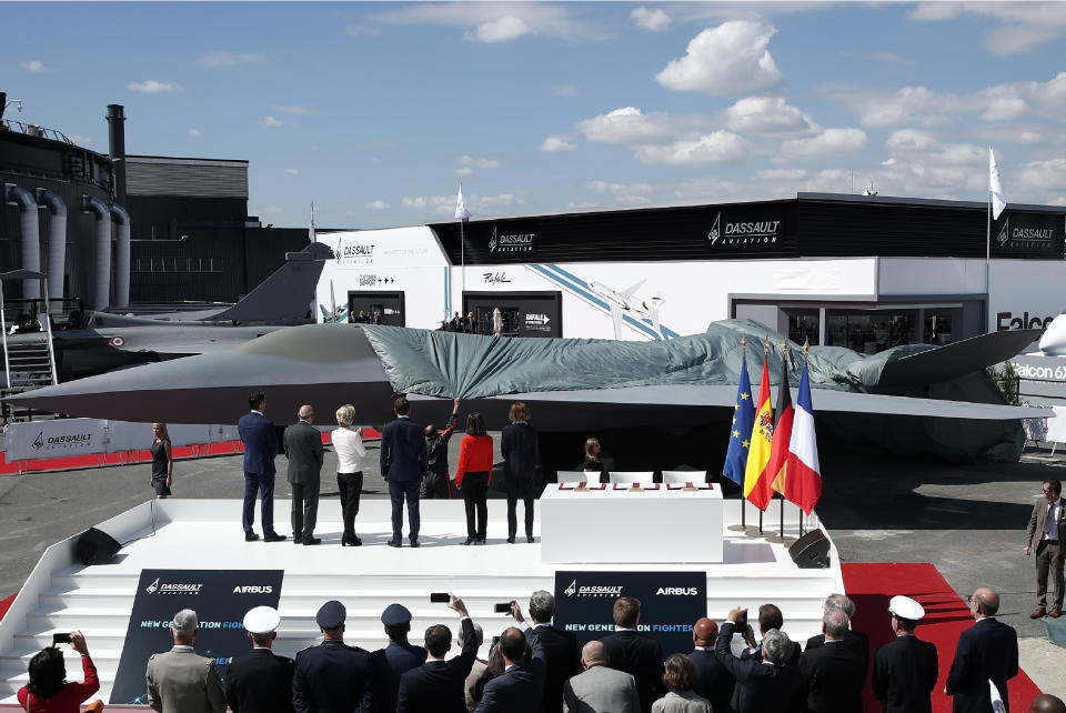 French President Emmanuel Macron, Eric Trappier, Chairman and CEO of Dassault Aviation, Dirk Hoke, CEO of Airbus Defense and Space, Spanish Defense Minister Margarita Robles, German Defense Minister Ursula von der Leyen and French Defense Minister Florence Parly attend the unveiling of the French-German-Spanish New Generation Fighter (NGF) model during a visit at Le Bourget Airport near Paris, France, Monday June 17, 2019. The world's aviation elite are gathering at the Paris Air Show with safety concerns on many minds after two crashes of the popular Boeing 737 Max. (Benoit Tessier/Pool via AP)