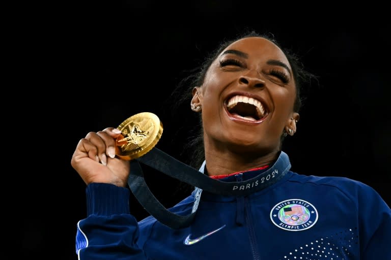 Beaming Biles bags Olympic gymnastics triple, as women's 100m final looms