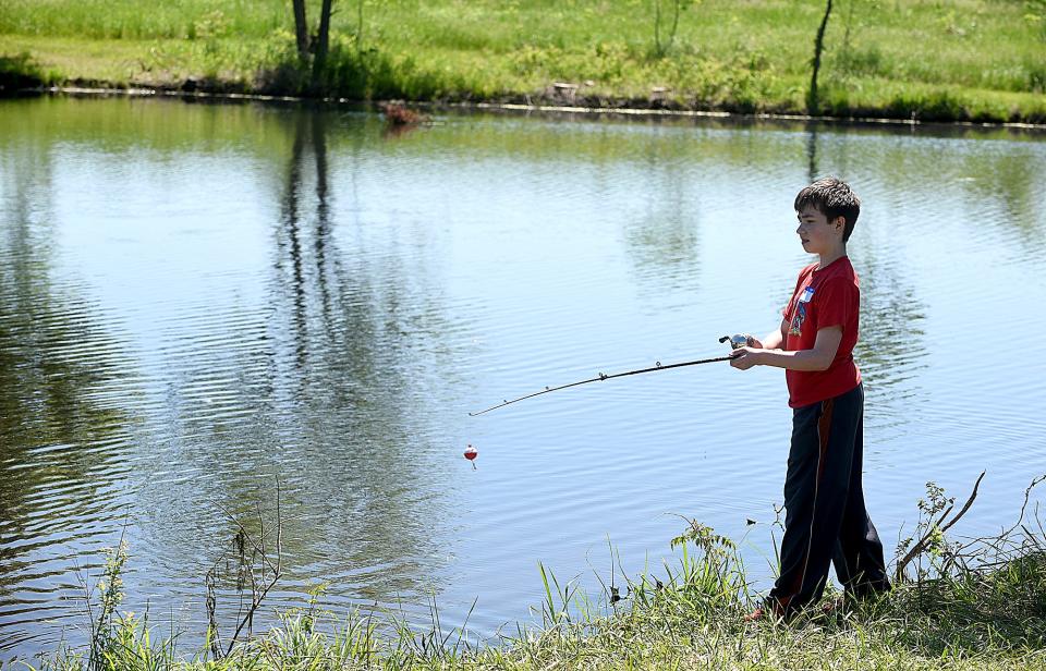 Wyatt Riffle, 12, a sixth grader at Gentry Middle School, casts his fishing line on Monday at the Boone County Nature School.