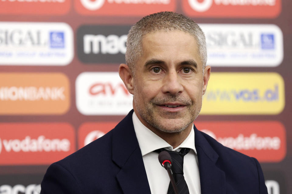 The new coach of Albania national soccer team Brazilian Sylvio Mendes Campos smiles during a press conference in Tirana, Albania, Monday, Jan. 9, 2023. The Albanian soccer federation has signed an 18-month contract with Sylvio Mendes Campos Junior to coach the country’s national team aiming at reaching the 2024 Euro finals. The Brazilian, 48, known as Sylvinho, signed a contract on Monday to lead the Albanian national team until the end of European Championship. No financial details were made available. (AP Photo/Franc Zhurda)