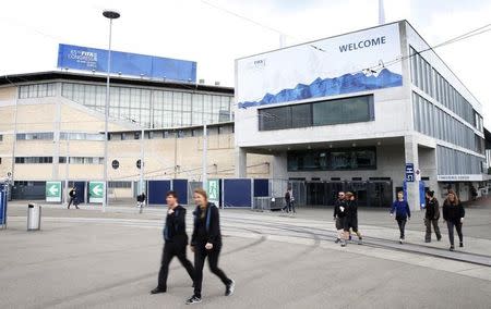 People walk in front of the Hallenstadion, where the upcoming 65th FIFA Congress will take place in Zurich, Switzerland, May 27, 2015. REUTERS/Arnd Wiegmann