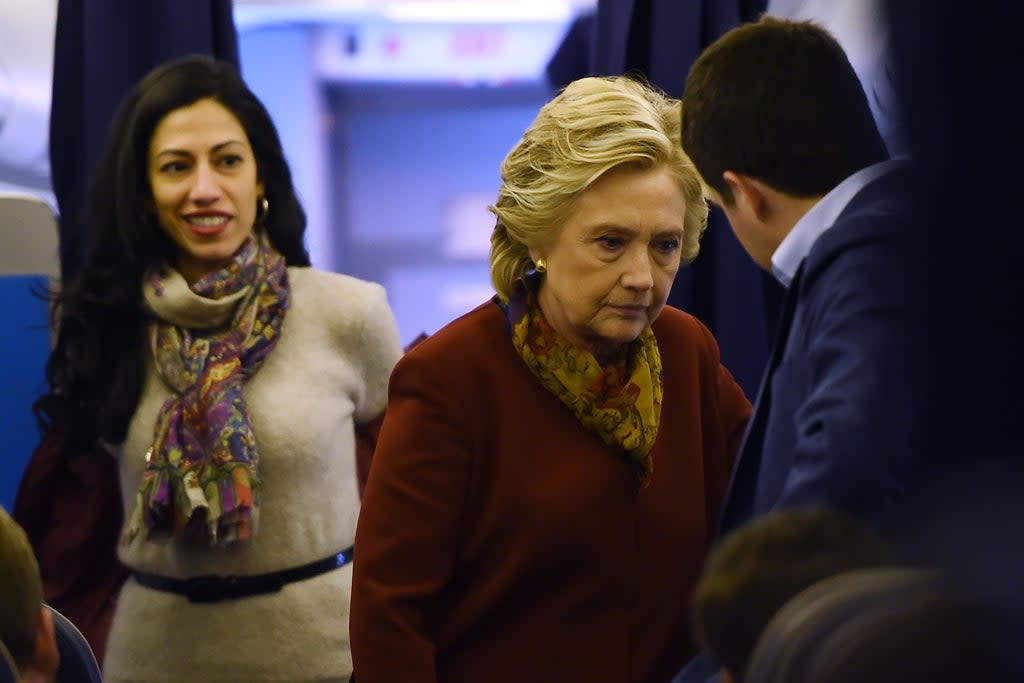 Democratic presidential nominee Hillary Clinton chats with her staff, including aide Huma Abedin (L), onboard her plane in White Plains, New York, October 22, 2016, on her way to a campaign event in Pittsburgh, Pennsylvania. (AFP via Getty Images)