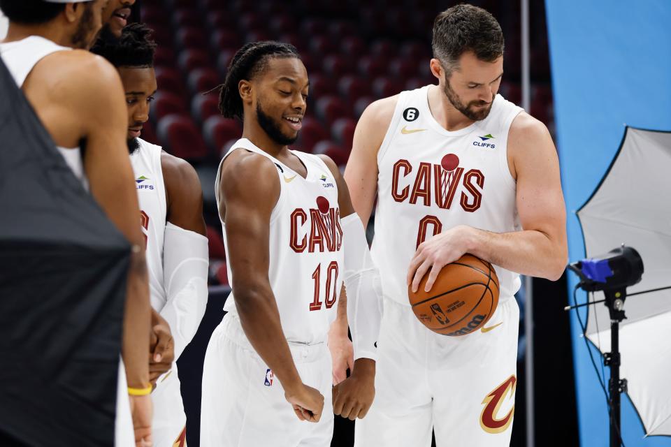Cleveland Cavaliers guard Darius Garland (10) flexes next to Kevin Love (0) before having a portrait shoot during the NBA basketball team's media day, Monday, Sept. 26, 2022, in Cleveland. (AP Photo/Ron Schwane)