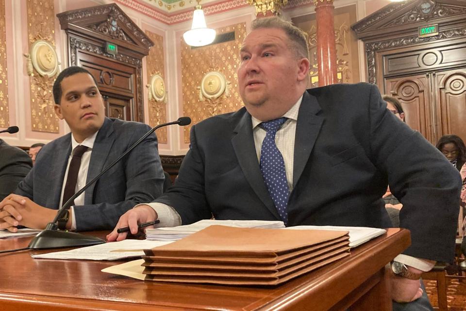 FILE - Illinois state Sen. Scott Bennett, D-Champaign, right, explains clarifications to the SAFE-T Act criminal justice overhaul he co-sponsored before the Senate Executive Committee on Dec. 1, 2022, at the state Capitol in Springfield, Ill. Bennett, a key legislative negotiator on clarifying the landmark SAFE-T Act criminal justice overhaul that takes effect Jan. 1, 2023, died Friday, Dec. 9. He was 45. (AP Photo/John O'Connor, File)