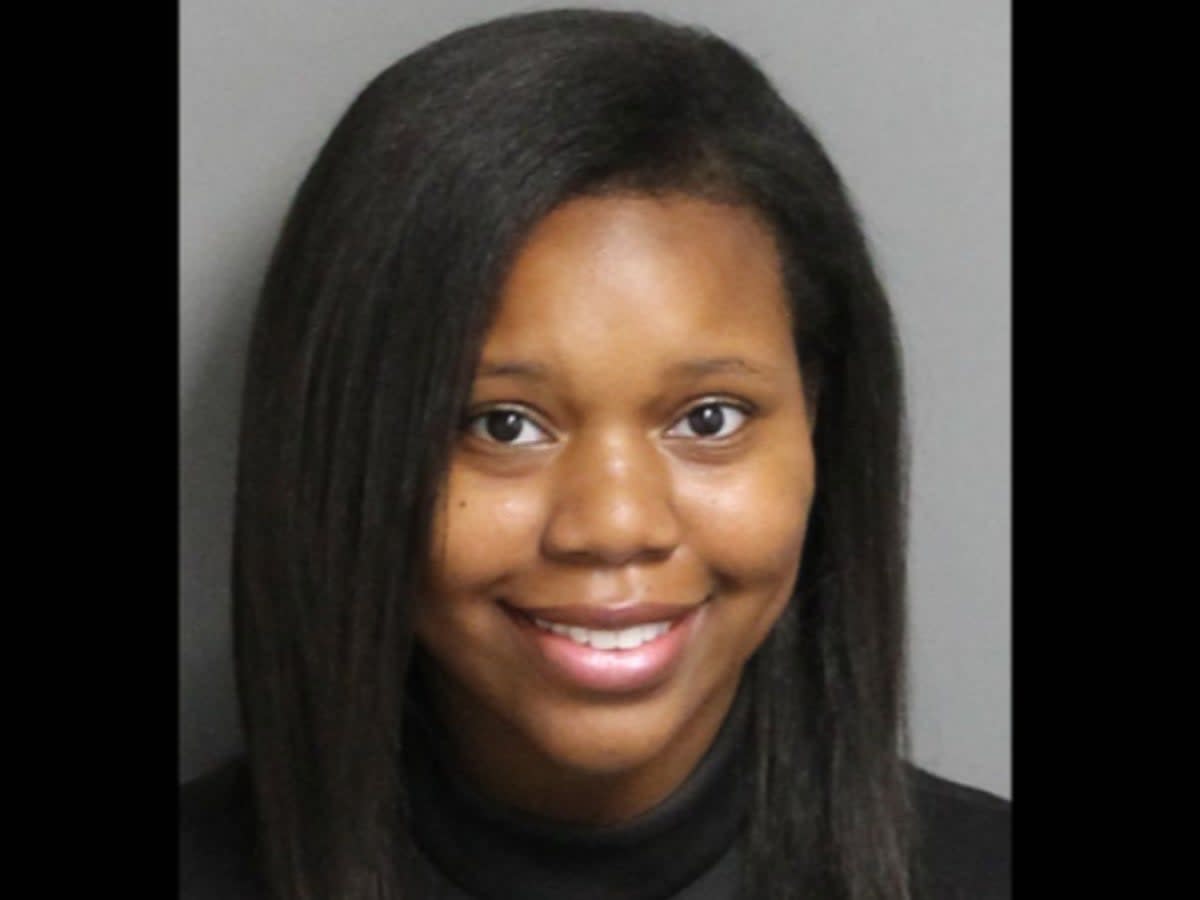 Carlee Russell smiles in her mugshot  (Hoover Police Department)