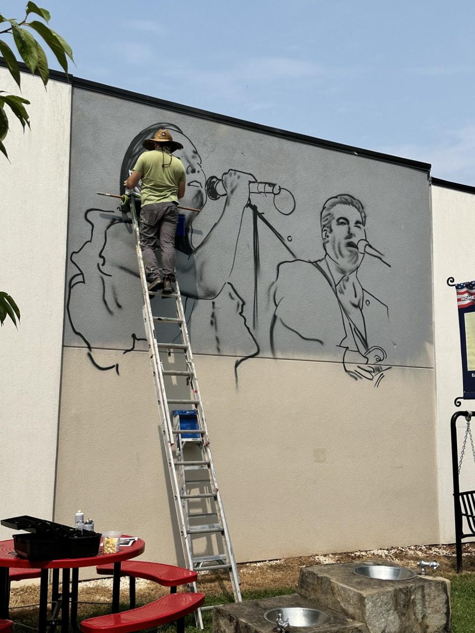 Muralist Scott Nurkin working on the new mural in the summer of 2023.