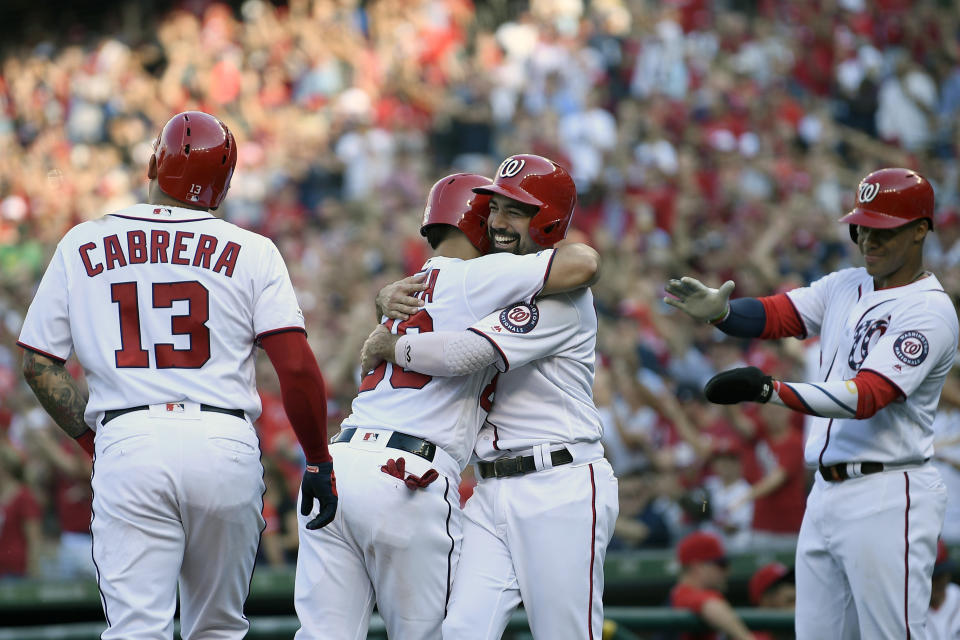 Washington Nationals' Gerardo Parra, second from left, celebrates his grand slam as he hugs Anthony Rendon, second from right, during the second inning of a baseball game against the Cleveland Indians, Saturday, Sept. 28, 2019, in Washington. Nationals' Asdrubal Cabrera (13) and Juan Soto, right, look on . (AP Photo/Nick Wass)
