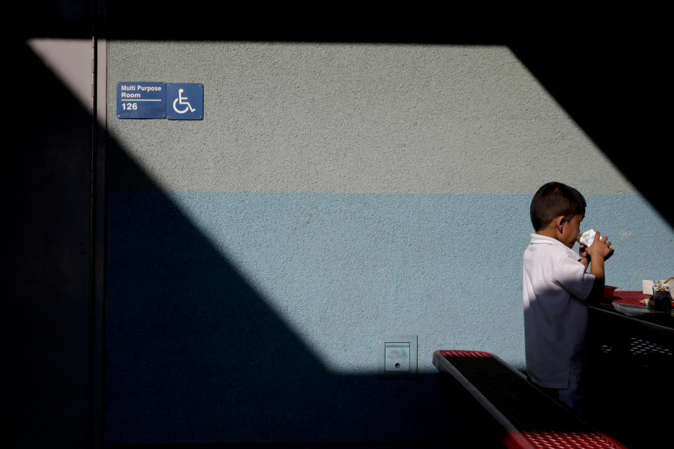 FILE - Joshua Beltran drinks his milk in the cafeteria area at Kingsley Elementary School, Jan. 13, 2015, in Los Angeles. Friday, May 17, 2024, marks 70 years since the U.S. Supreme Court ruled that separating children in schools by race was unconstitutional. (AP Photo/Jae C. Hong, File)