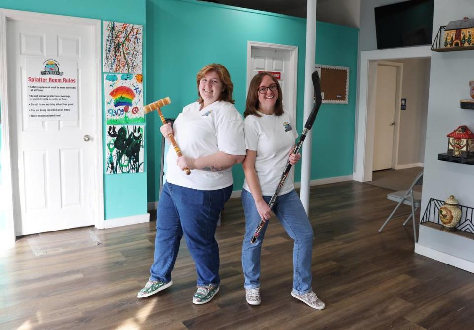 Heidi Inman, left, and Cheryl Yeager, co-owners of T-Wrecks Smash and Paint Splatter Rooms stand in their store on East Main Street in Rock Hill.