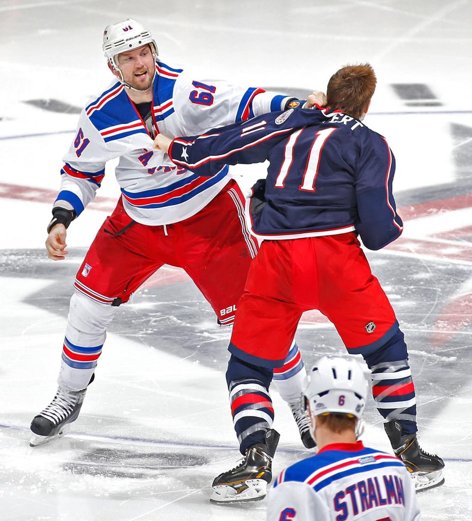 New York Rangers left wing Rick Nash (61) and Columbus Blue Jackets left wing Matt Calvert (11) fight during a March 19, 2014 game.