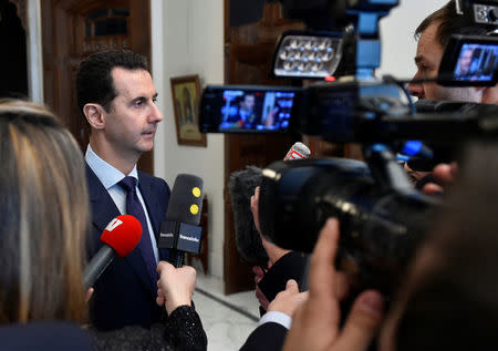 Syria's President Bashar al-Assad speaks to French journalists in Damascus, Syria, in this handout picture provided by SANA on January 9, 2017. SANA/Handout via REUTERS