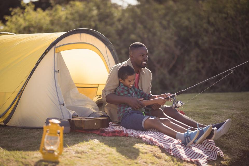 summer activities with father and son fishing together in a park