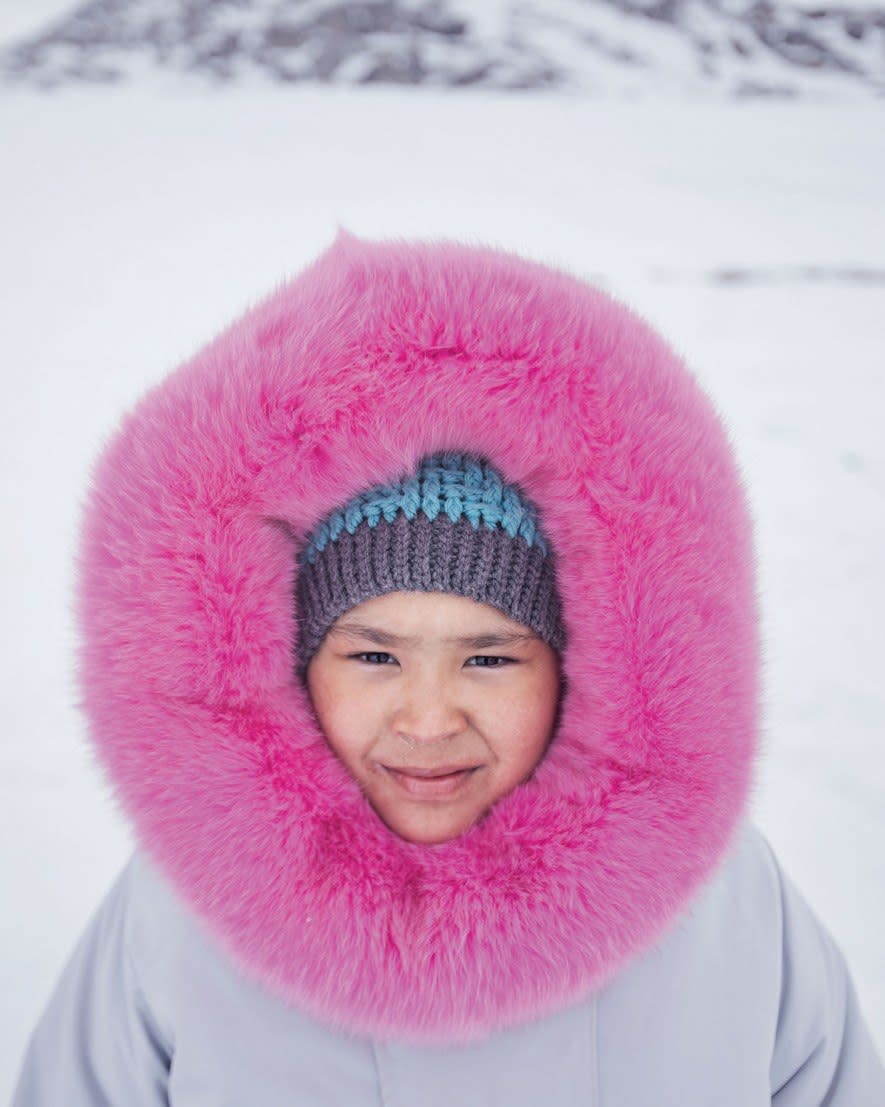 Wearing a parka sewn by her mother, Ashley Hughes spent her 10th birthday camping with friends and family at Ikpikittuarjuk Bay. Hughes took part in the Inuit community’s annual ice fishing competition for arctic char. (National Geographic/David Guttenfelder)