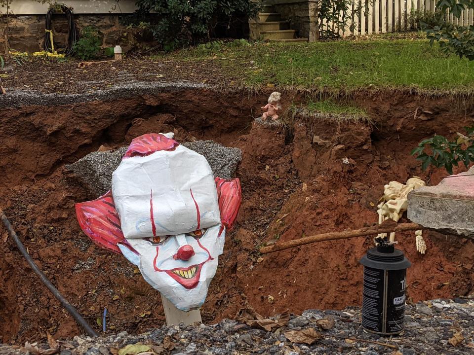 For Halloween, Nat Dickinson created a scary clown head for the sinkhole next door to his Montford home. Residents of the home where the sinkhole emerged installed it.